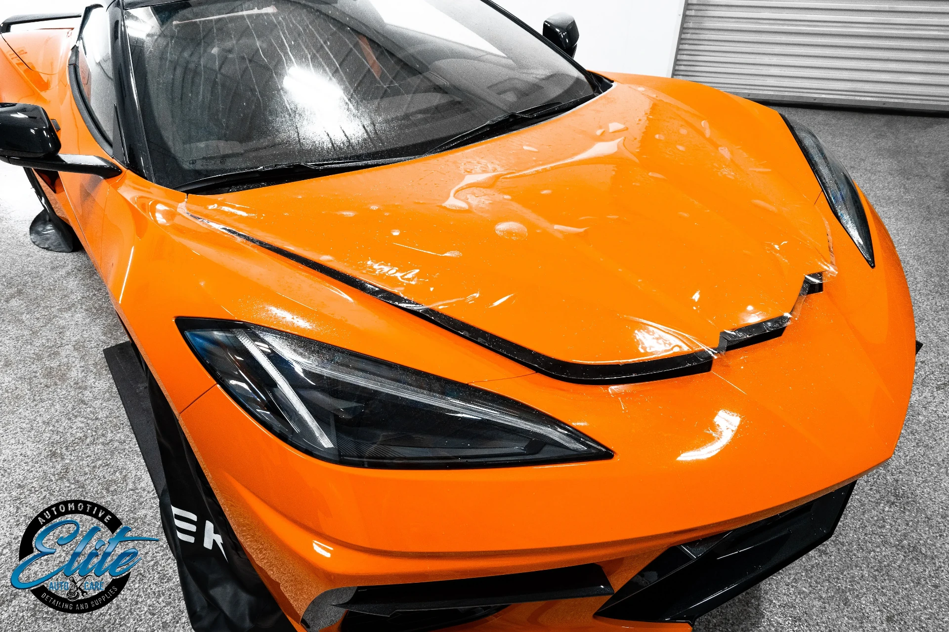 Paint protection film being installed on a sports car hood at Elite Auto Care